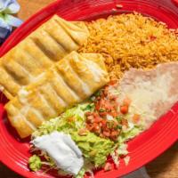 Chimichanga · A flour tortilla stuffed with your choice of chicken or beef, and deep fried, served with ch...