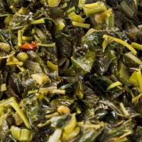 Callaloo · Jamaican spinach sautéed with onions, scotch bonnet peppers, tomatoes and spices.