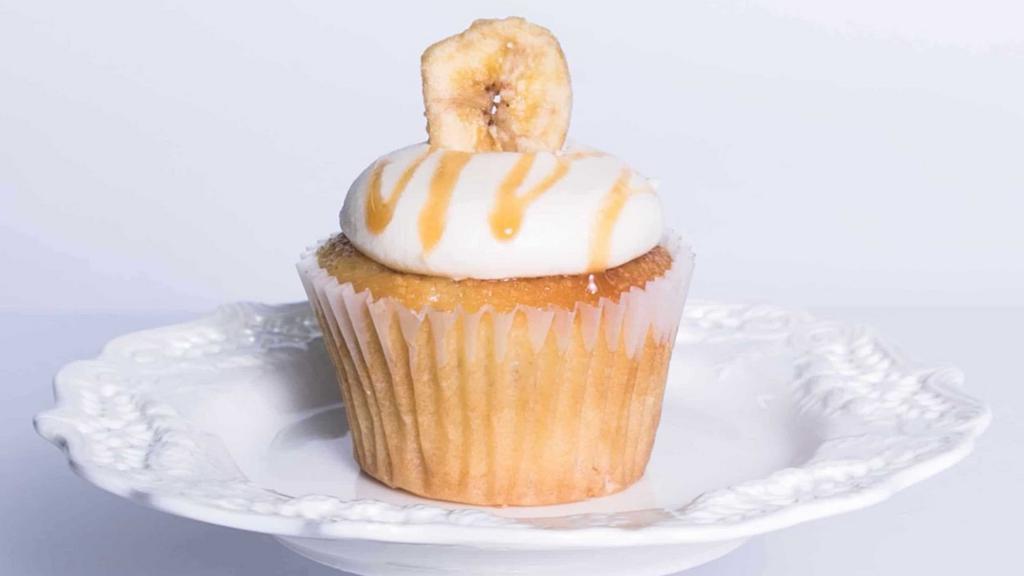 Banana Cream · Moist banana cake topped with creamy banana flavored Cream cheese frosting, drizzled in caramel sauce and garnished with a banana chip.
