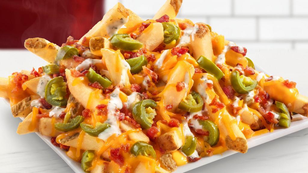 Jalapeno Pepper Fries · Cheddar cheese sauce, diced jalapeños, jalapeño lime seasoning, ranch dressing, shredded cheddar, bacon.