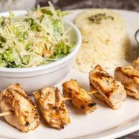 Chicken Skewer · Grilled chicken breast chunks on skewer, with tzatziki on the side and 2 sides of your choice.