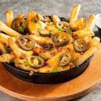 Texas Cheese Fries - Half · Shredded cheese, bacon, jalapeños, green onions. Served with house-made ranch.