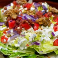Bleu Cheese Wedge Salad · Crisp iceberg, tomato, red onion, bacon, candied pecans, Bleu cheese dressing, and Bleu chee...