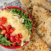 Arugula & Focaccia Salad · Arugula, fresh tomatoes, and shaved parmesan cheese with a side of focaccia bread. Served wi...
