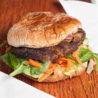Black Bean Burger (Soy Free) · Grilled black bean burger on crushed wheat bun. Served with shredded carrots, spinach, lettu...