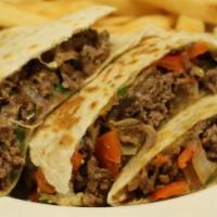 Steak Quesadilla · Grilled Steak with peppers, onions, and cheddar cheese served with sour cream