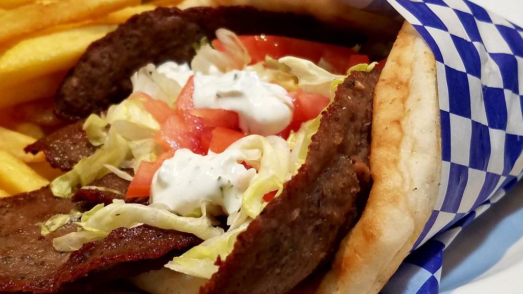 Lamb Gyro · Greek style seasoned lamb cooked on a spit and wrapped in a pita with lettuce, tomato, and a side of tzatziki sauce.