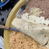 Burrito Asado · Choice of chicken or steak topped with jalapeño cheese dip, served with beans and rice.