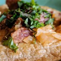 Carnitas Dinner · Fried pork tenderloin with guacamole salad, flour tortillas, beans, and rice.