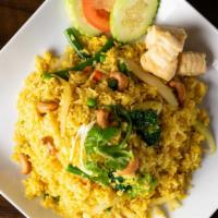 Thai Pineapple Fried Rice · Fried rice with egg, onion peas, carrot, yellow curry powder, pineapple and cashew nuts.