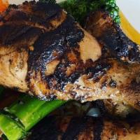 Grilled Jamaican Jerk Chicken · Served with vegetable and tomato wild rice, sautéed broccolini and peach habanero puree.