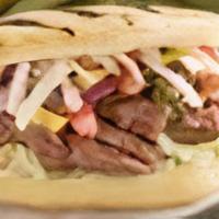 Arepa Carne Asada · Grilled steak,  green cabbage, paisa cheese, pico de gallo with our homemade garlic sauce.