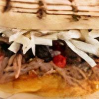 Arepa Pabellon · Shredded beef, black beans, sweet plantains and paisa cheese.