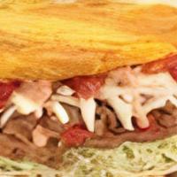 Patacon Shredded Beef · Fried green plantain topped with your choice of meat, cabbage, paisa cheese, garlic sauce, p...