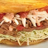 Patacon Steak · Fried green plantain topped with your choice of meat, cabbage, paisa cheese, garlic sauce, p...