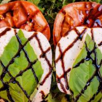 Caprese Salad · Fresh mozzarella, beefsteak tomato, basil, balsamic glaze, and arugula.