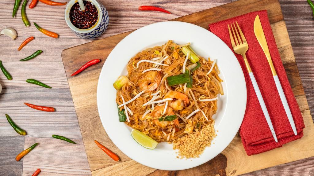 Pad Thai · Most popular stir fried rice noodle with egg, scallion and bean sprout, garnished with crusted peanut and slice of lime.