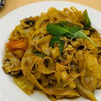 Pad Kee Mao · Spicy. Drunken noodle. Stir fry wide noodle with egg, bell pepper, tomato, baby corn, onion,...