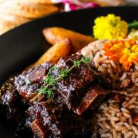 Braised Oxtails & Beans · Authentic Jamaican Braised Oxtails, cooked to perfection with herbs and spices, finished off...