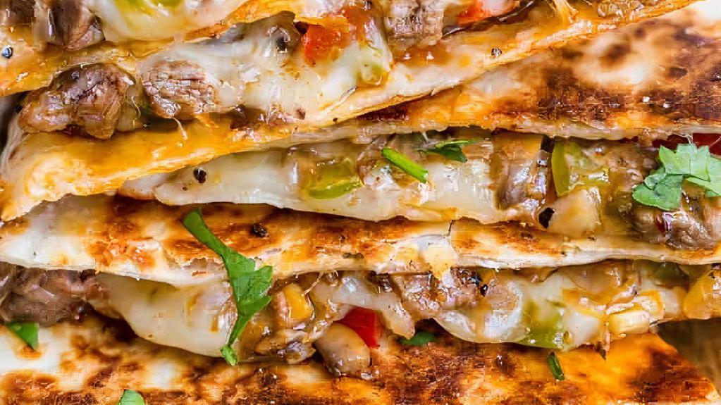 Philly Cheesesteak Quesadilla · Thinly slice steak, sautéed onions, peppers, mushrooms and cheese.