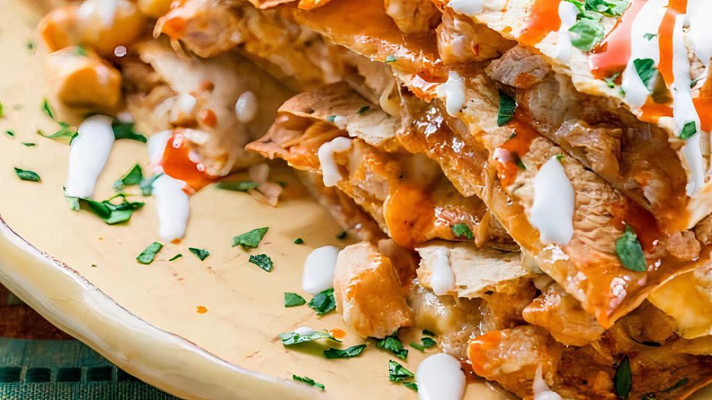 Buffalo Chicken Quesadilla · Seasoned grilled chicken, buffalo wing sauce, ranch dressing and cheese all mixed up together with a hint of blue cheese.