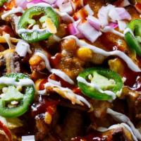 Bbq Chicken Nachos · queso, buffalo chicken, lettuce, tomatoes, jalapeños and BBQ sauce.