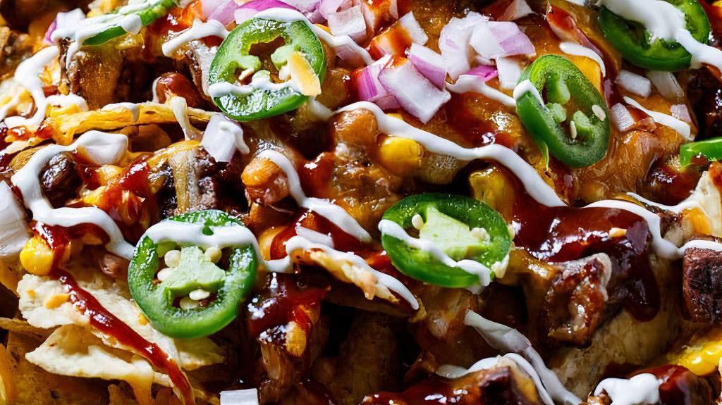 Bbq Chicken Nachos · queso, buffalo chicken, lettuce, tomatoes, jalapeños and BBQ sauce.