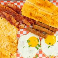 Completa De Desayuno / Breakfast Meal · Dos huevos fritos o revueltos con tocino o salchicha, y tostada. / Two eggs fried or scrambl...