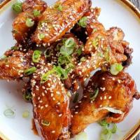 Sticky Wings · 24 hour brined wings, sweet soy glaze, scallions, sesame seeds with Asian pickles, and ranch.