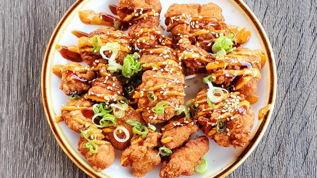 Chicken Karaage · Twice fried chicken dark meat, spicy mayo, and eel sauce topped with sesame seeds and scallions.