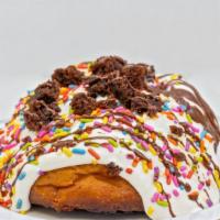 Birthday Cake Remix Cinnamon Roll · Frosting, rainbow sprinkles, brownies, chocolate drizzle