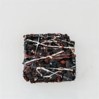 Loaded Brownie · Vegan. Vegan chocolate brownie with chocolate chips and white chocolate drizzle.