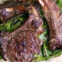 Zattar Lamb Chops · New Zealand Baby lamb chop with a bed of Hummes and and arugula salad.