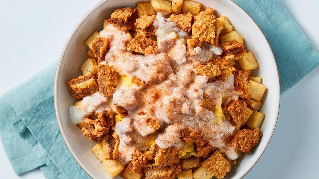 Chicken Fried Steak Bowl · Feeling country? Seasoned country potatoes topped with scrambled eggs mixed with sautéed diced yellow onions, chicken-fried steak and smothered in country sausage gravy.