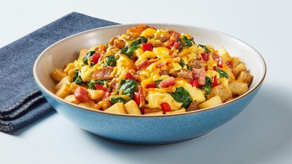 Everything But The Kitchen Sink Bowl · Craving everything? Well, we've got you. Our seasoned country potatoes topped with scrambled eggs mixed in with sautéed red peppers, spinach, diced ham, sausage crumbles, and chopped bacon, then sprinkled with cheddar cheese.