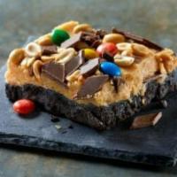 Felony Fudge · Creamy peanut butter, M&Ms®, peanuts and chocolate candy layered on a rich, OREO® Cookie cru...