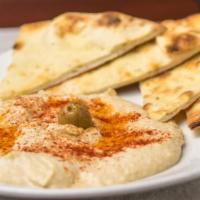 Hummus (V) · Vegetarian. Combination of garbanzo beans mixed with tahini, garlic, fresh lemon juice and o...
