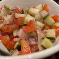 Shirazi Salad (V) · Vegetarian. Freshly diced cucumbers, tomatoes, onions, herbs, fresh lemon juice and olive oil.