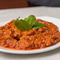 Mirza Ghasemi (V) · Vegetarian. Smoked roasted eggplant with cooked tomatoes and garlic.