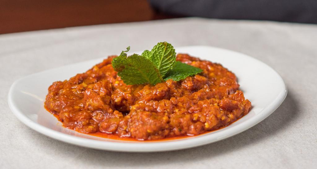 Mirza Ghasemi (V) · Vegetarian. Smoked roasted eggplant with cooked tomatoes and garlic.