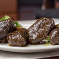 Dolmeh · Grape leaves stuffed with rice, ground beef, chives, tarragon, parsley, cilantro and raisins.