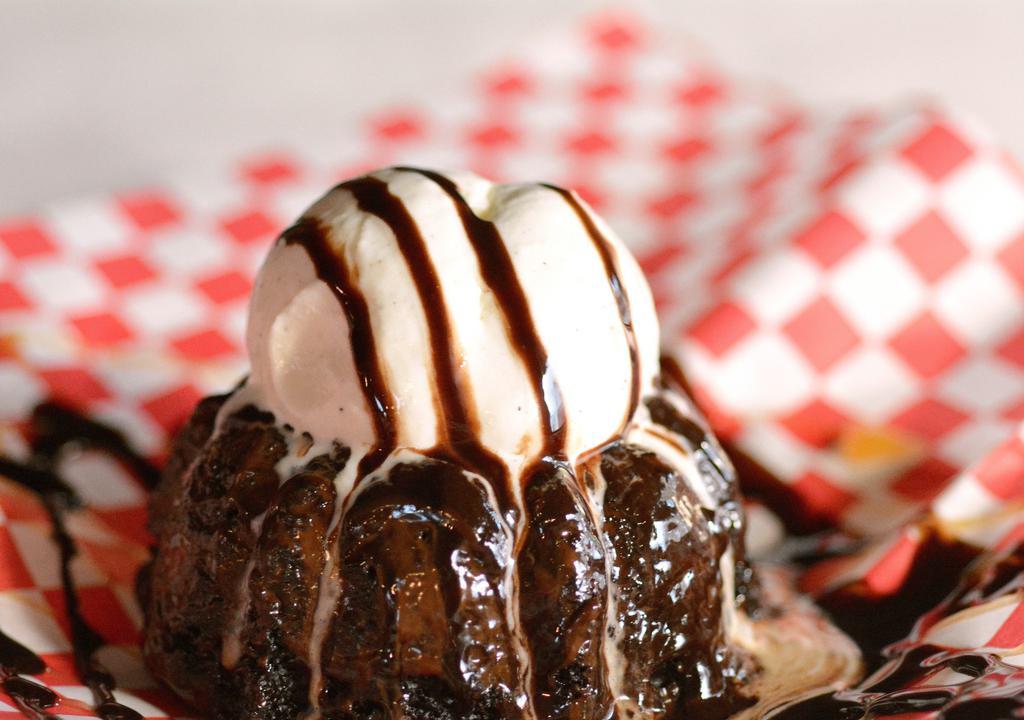 Molten Chocolate Cake/ Ice Cream · Decadent chocolate cake with a gooey ganache center topped with vanilla ice cream, caramel and chocolate syrup