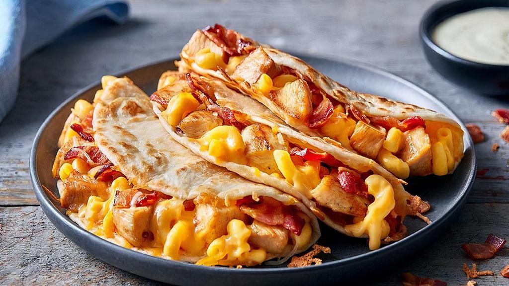 Chicken, Bacon, Mac & Cheese Quesadillas · Meat and cheese and meat and cheese. Roasted pulled chicken, chopped smoky bacon and gooey mac & cheese, mixed with more melted blended cheese and served in 3 grilled flour tortillas. Served with ranch dressing. Served with a side of Papa’s Tortilla Chips