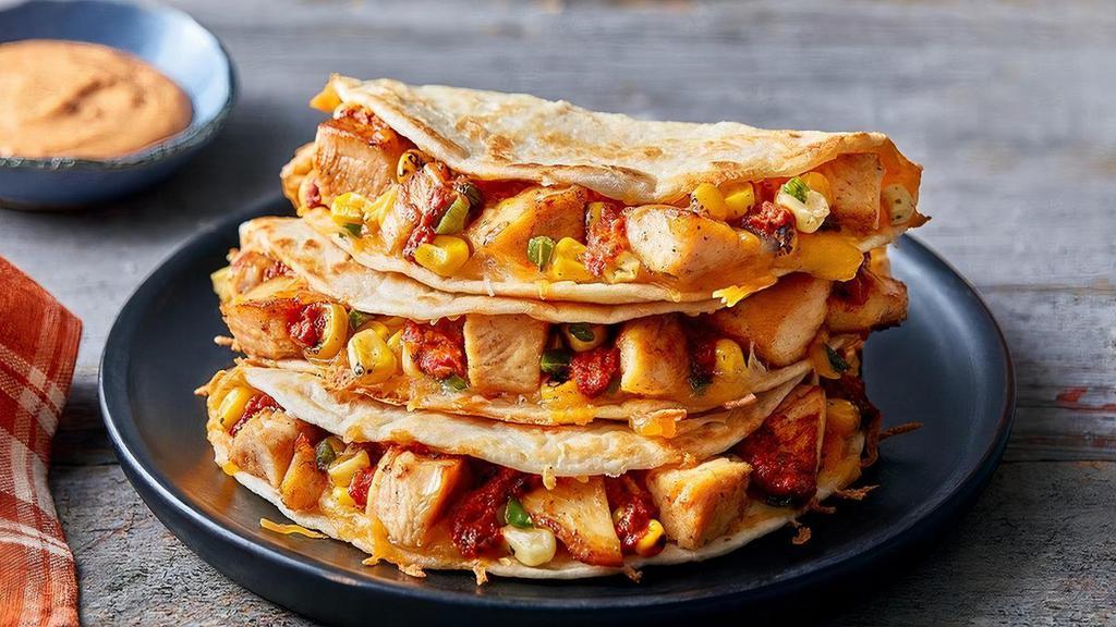 Chicken Fajita Quesadillas · Fajitas done Papa’s way. Marinated grilled chicken breast, fire-roasted corn, melted blended cheese and a red pepper sauce. Served in 3 grilled flour tortillas with your choice of dipping sauce. Served with a side of Papa’s Tortilla Chips