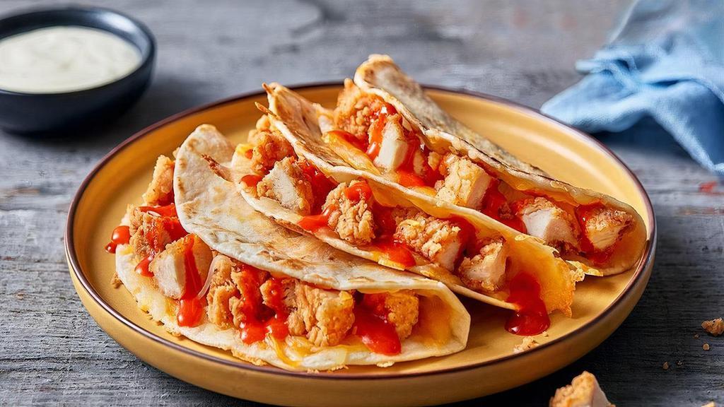 Buffalo Chicken Quesadillas · It’s not buffalo wings… it’s even better. Crispy fried chicken tenders covered in buffalo hot sauce and melted blended cheese. Served in 3 grilled flour tortillas with ranch dressing.  Served with a side of Papa’s Tortilla Chips