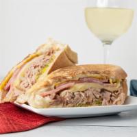 Cuben Sandwich · Pork, ham, Swiss cheese, pickles, mustard dressing on toasted garlic bread.