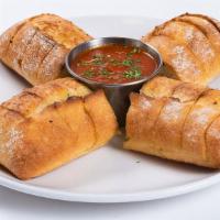 Garlic Bread · Our artisan garlic bread is buttered and baked to perfection, and served with a side of warm...