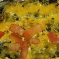 Veggie Potato · Mushrooms, broccoli, spinach, green peppers onions, cheese and topped with tomatoes and chiv...