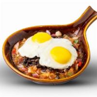 Huevos Rancheros · 2 eggs any style topped with sauteed tomatoes, peppers, onions, and black beans. Garnished w...