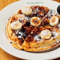Banana Bread Waffle · Our Signature Waffle baked with pecans, topped with ripe bananas, & dashed with powdered sug...